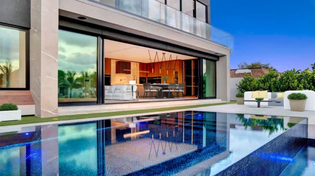 New, Noteworthy, and Next-Level 💥 | Asking: $4,495,000 
​
Welcome to… 321 SE 14th Ave, Pompano Beach, FL 33060 📍
​
It was all a dream! Brand new construction with every bell and whistle you can dream of. Step through the pivot front door to a jaw dropping floating staircase, earthy tones, good energy, clean lines, this waterfront 5 bed, 5.5 bath is a true showstopper. The custom kitchen has Wolf & Jenn Air appliances, Taj Marble counters, wine and liquor cabinets! The kitchen opens to the living room with Italian oak paneled walls, a fireplace with expansive 33’ of floor to ceiling glass with a view of the pool and canal. The primary suite has custom closets and a bath like you have never seen before, floating cabinets, towel warmers and even an Apple TV in the mirror. Mosaic tile infinity pool, turf yard, glass panels the list goes on. The house is 100% smart with IPADS in each room. ONE OF A KIND!
​
📍| Pompano Beach, FL
🛏️| 5 Bedrooms
🛁| 5 Bathrooms | 1 Half Bathroom
📐| 4,073 Interior Square Feet
​
Want More Details?
📲| 305.400.9507
✉️| Info@TheChadCarrollGroup.Com
​
@austinwbergman | @thecarrollgroup | @compassfl